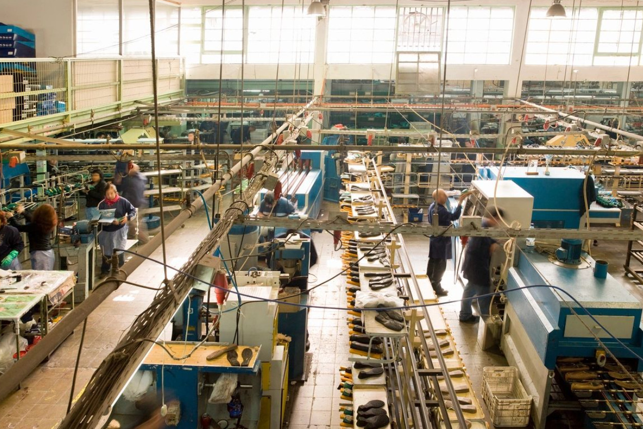 A factory floor with many workers working on it.